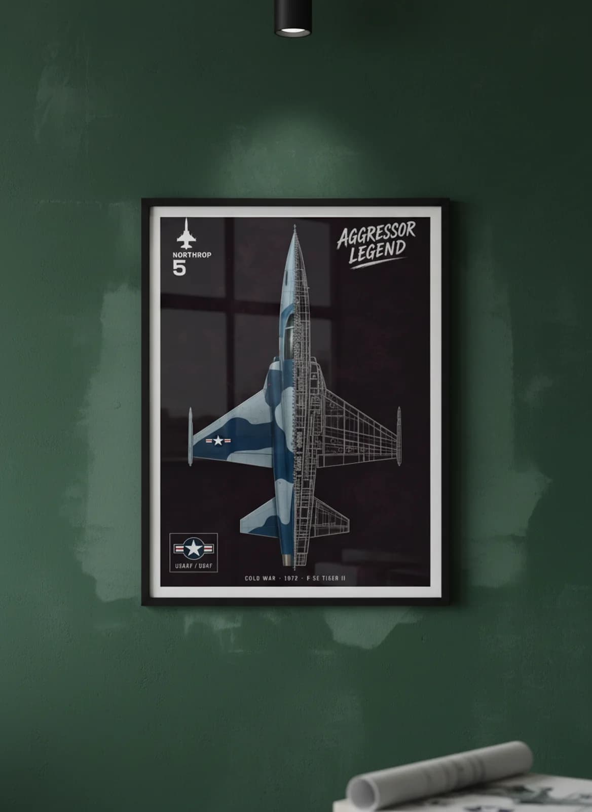 F-5E Tiger II — Aircraft Cutaway cutaway poster in black A2 frame on aggressor-blue-camouflage deep forest wall — Aircraft Cutaways enthusiast study mockup