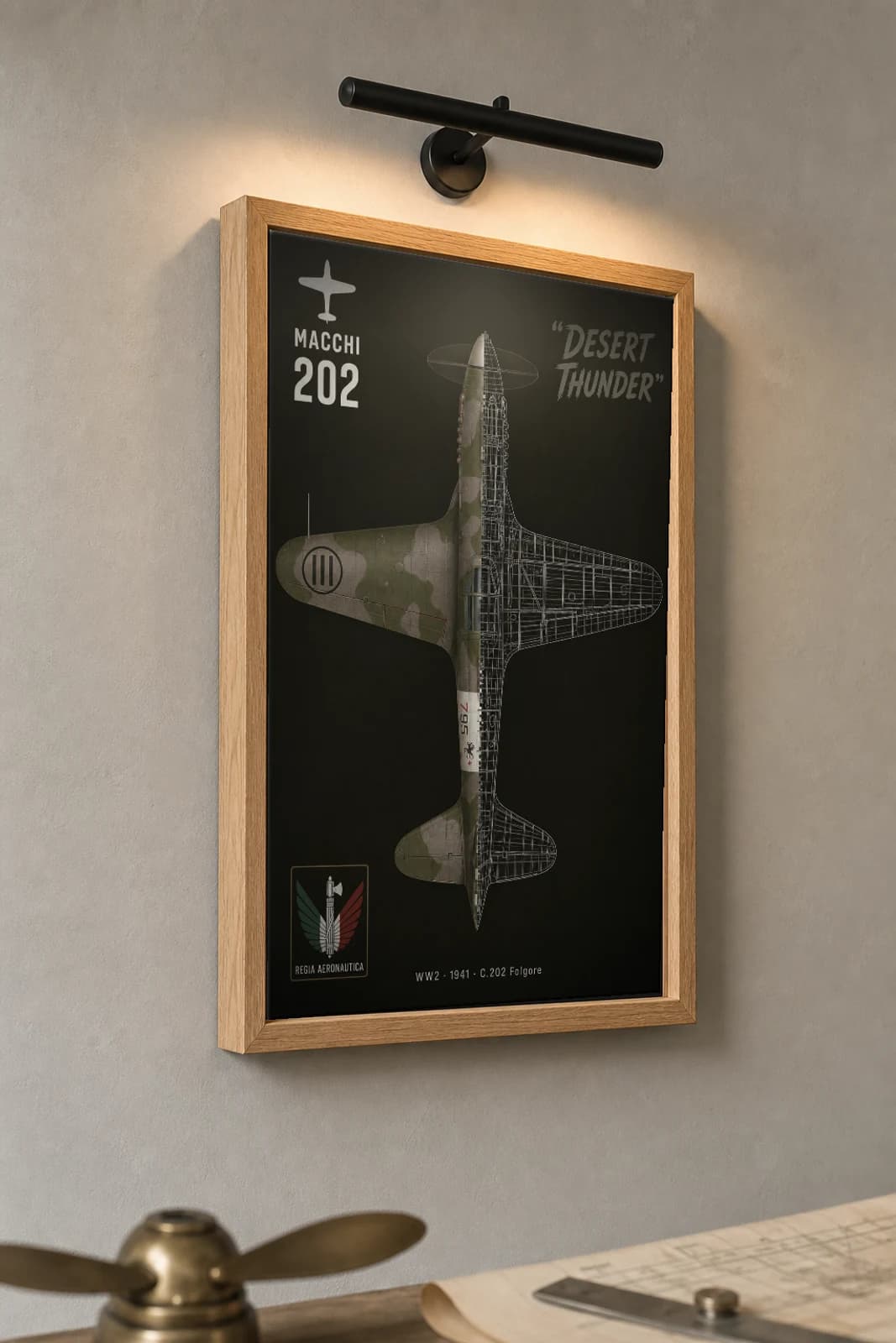Macchi C.202 Cutaway Poster — Folgore WW2 Split-View Blueprint Print — the framed print shown at a three-quarter angle on a styled gallery wall in a natural-oak frame