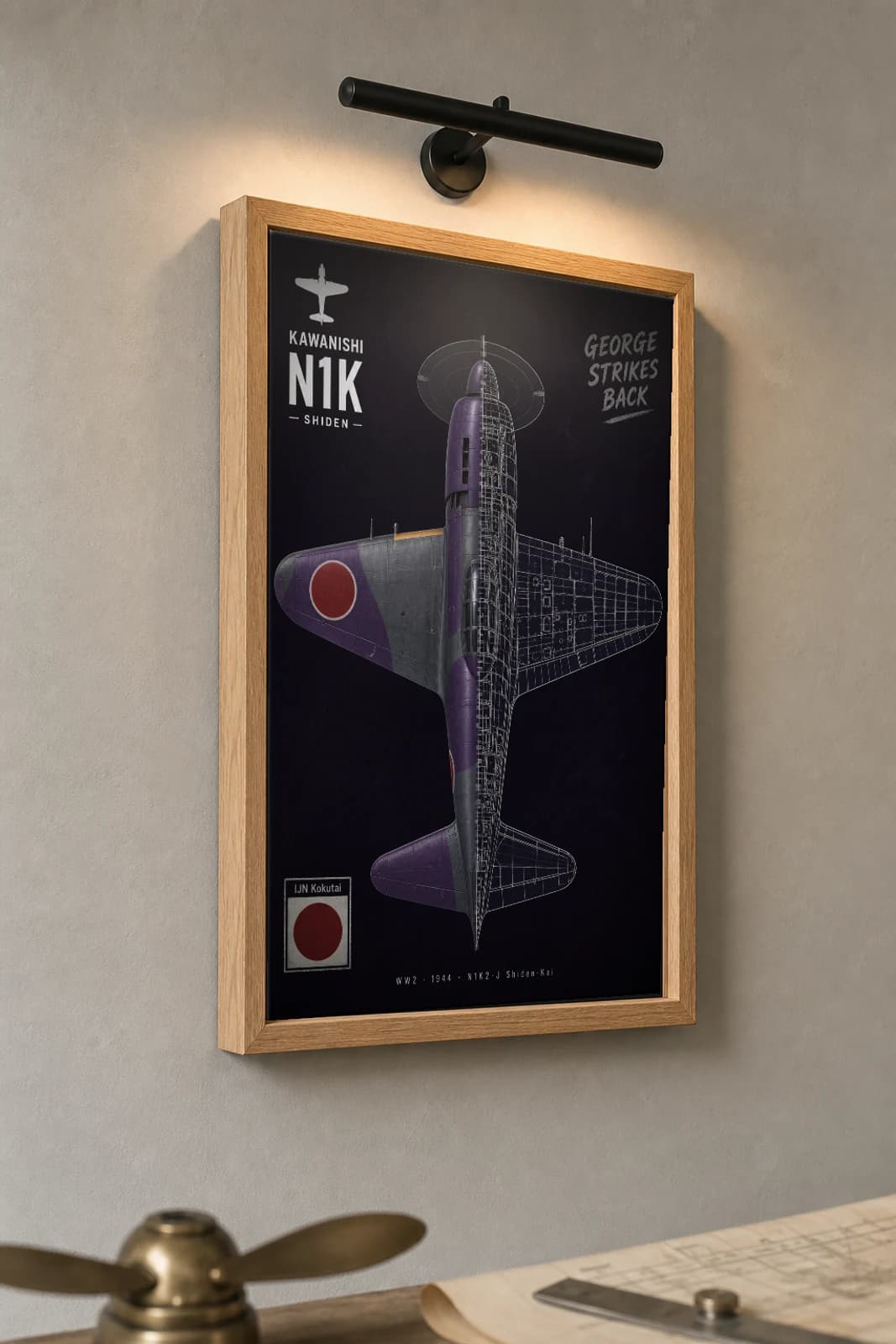 N1K2-J Shiden-Kai Cutaway Poster — N1K2-J George WW2 Split-View Blueprint Print — the framed print shown at a three-quarter angle on a styled gallery wall in a natural-oak frame