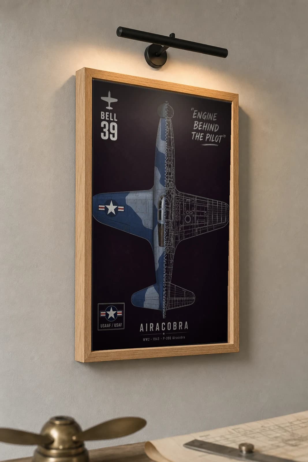 P-39 Airacobra Cutaway Poster — P-39Q WW2 Split-View Blueprint Print — the framed print shown at a three-quarter angle on a styled gallery wall in a natural-oak frame