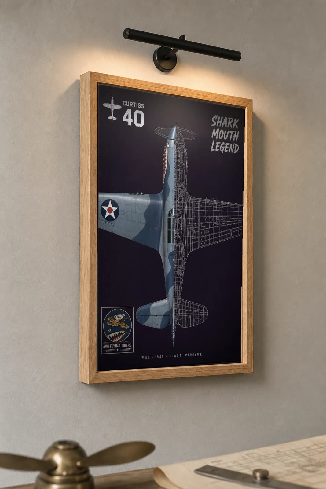 P-40 Warhawk Cutaway Poster — P-40E WW2 Split-View Blueprint Print — the framed print shown at a three-quarter angle on a styled gallery wall in a natural-oak frame