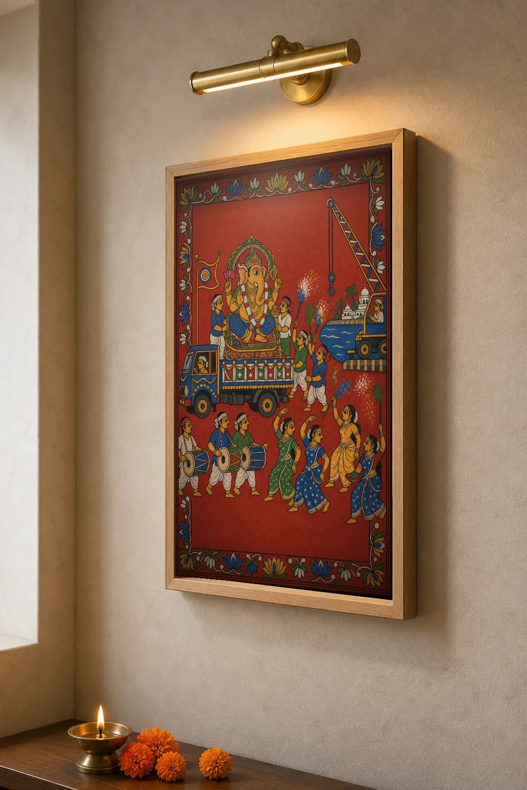 Ganesh Nimajjanam Cheriyal Fusion Print — A Ganesh Chaturthi Idol Carried to the Tank on a Lorry with Drummers and Dancers, Nakashi Folk Grammar on a Vermilion Ground — the framed print shown at a three-quarter angle on a styled gallery wall in a natural-oak frame