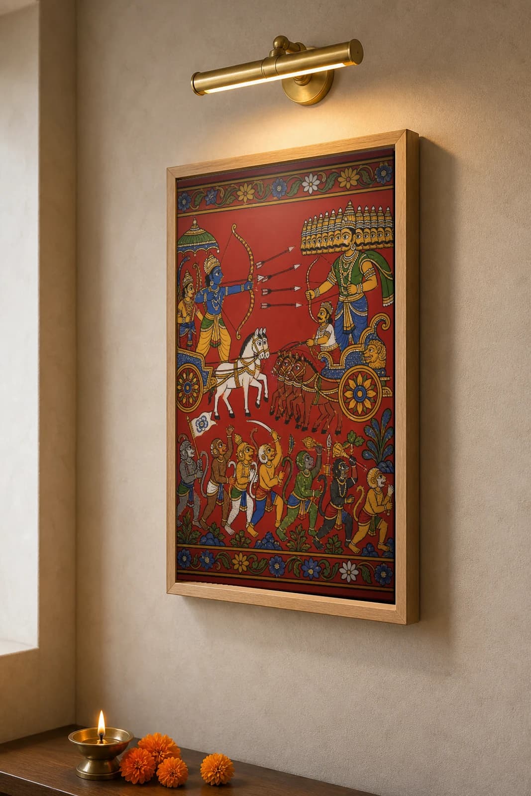 Rama vs Ravana War Cheriyal Print — the chariot duel of the ten-headed king and the vanara army below · collector edition on vermilion ground · Nakashi scroll grammar from Telangana — the framed print shown at a three-quarter angle on a styled gallery wall in a natural-oak frame