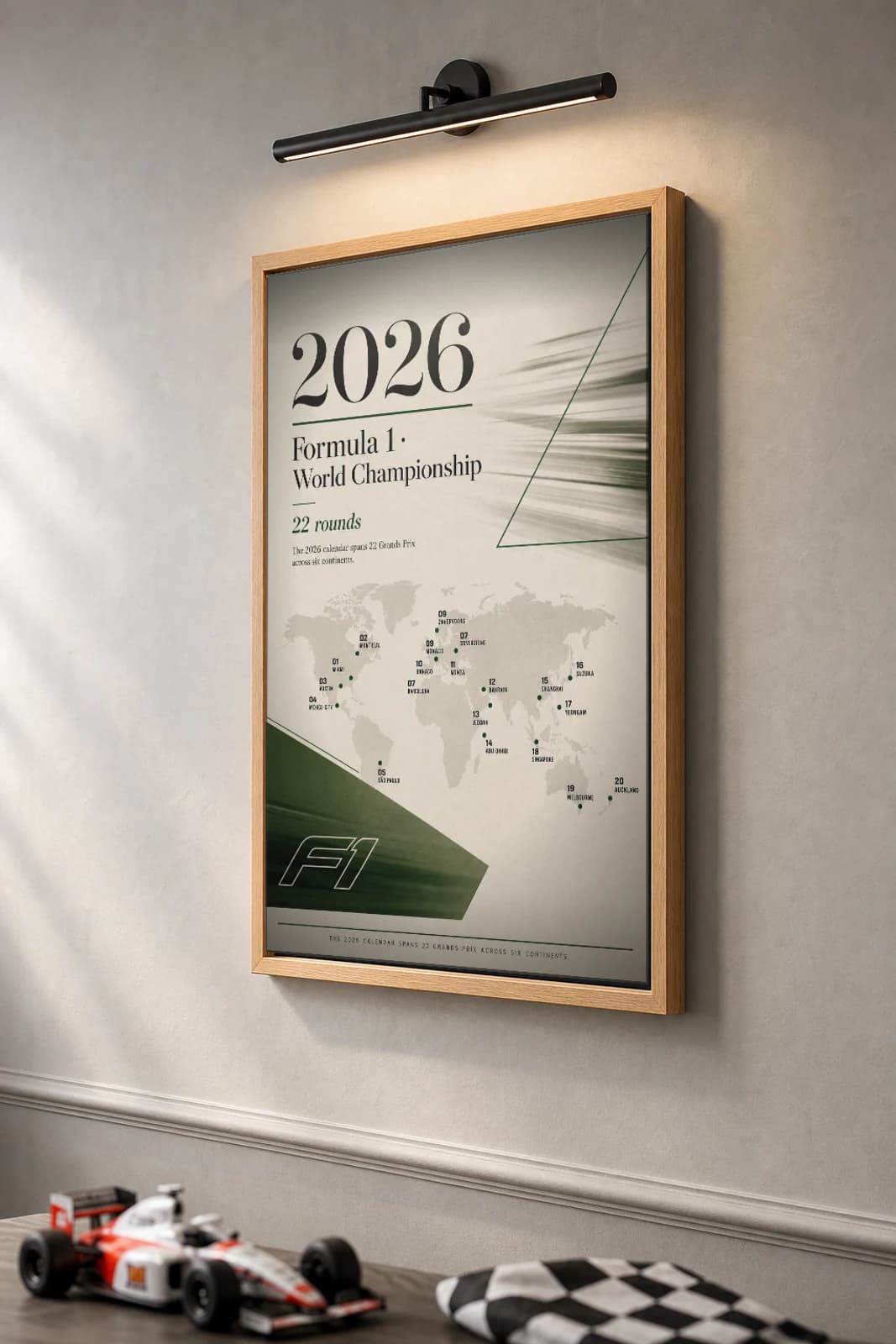 2026 Season — 2026 F1 calendar grid Poster — 2026 F1 Grid Editorial Wall Art · framed A2 — the framed print shown at a three-quarter angle on a styled gallery wall in a natural-oak frame