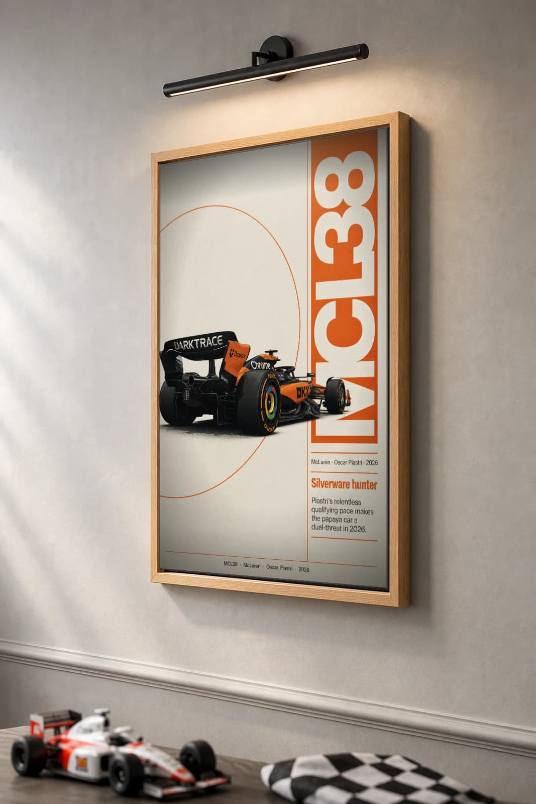 McLaren MCL38 — Oscar Piastri Poster — undefined F1 Grid Editorial Wall Art · framed A2 — the framed print shown at a three-quarter angle on a styled gallery wall in a natural-oak frame