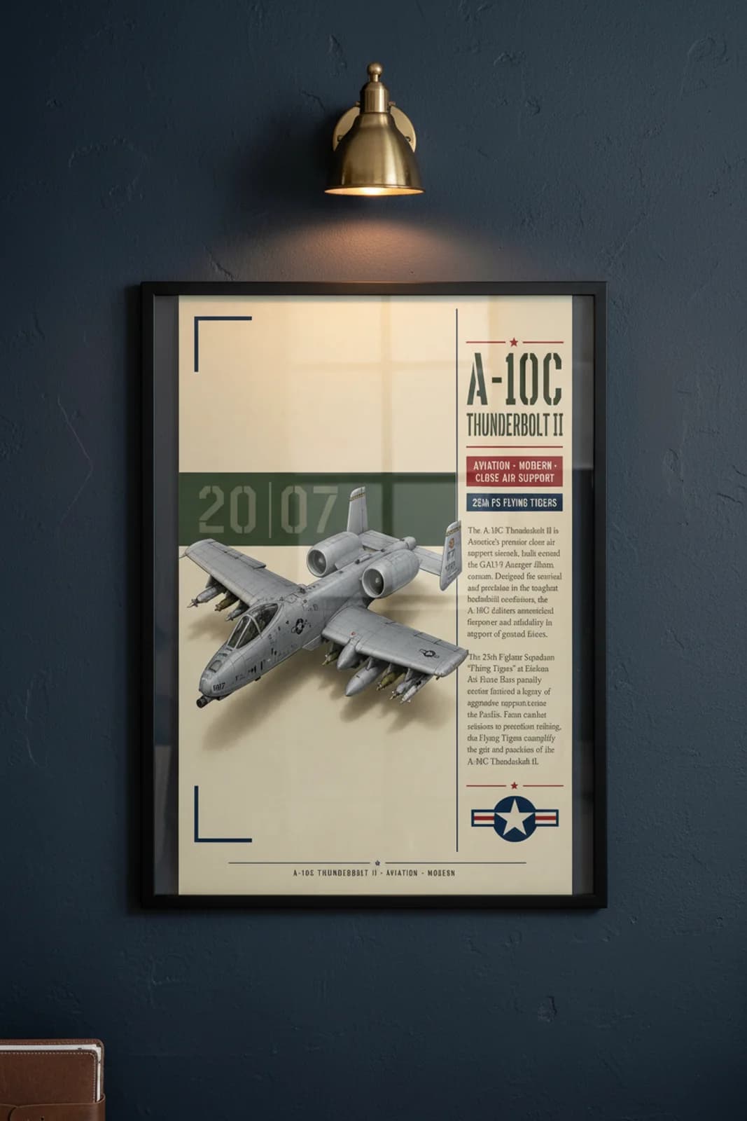 A-10C Thunderbolt II aviation poster in black A2 frame on usaf-grey navy hangar wall — Aviation Heroes mockup