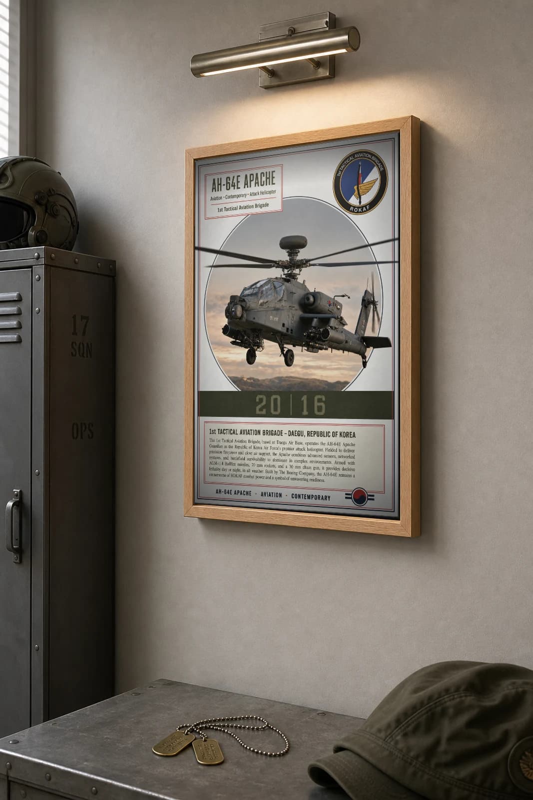 AH-64E Apache Poster — 1st Tactical Aviation Brigade military aviation wall art · framed A2 · 2016 — the framed print shown at a three-quarter angle on a styled gallery wall in a natural-oak frame
