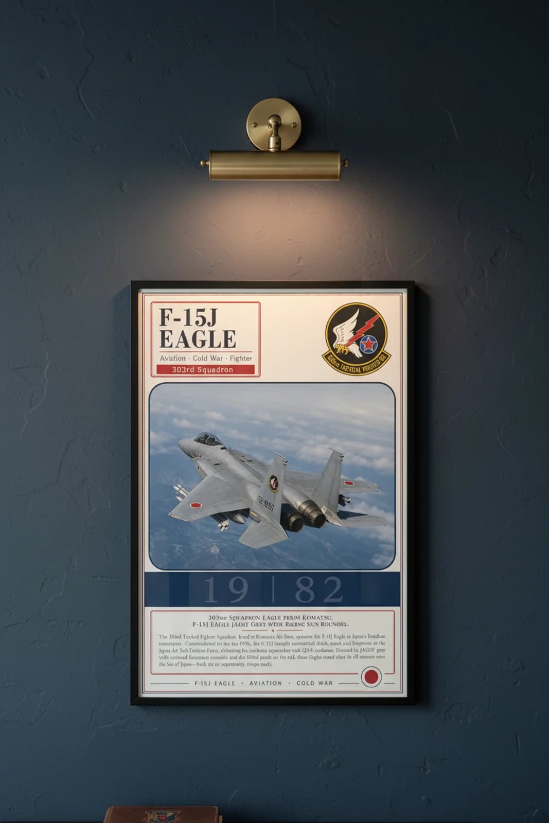 F-15J Eagle aviation poster in black A2 frame on jasdf-grey navy hangar wall — Aviation Heroes mockup