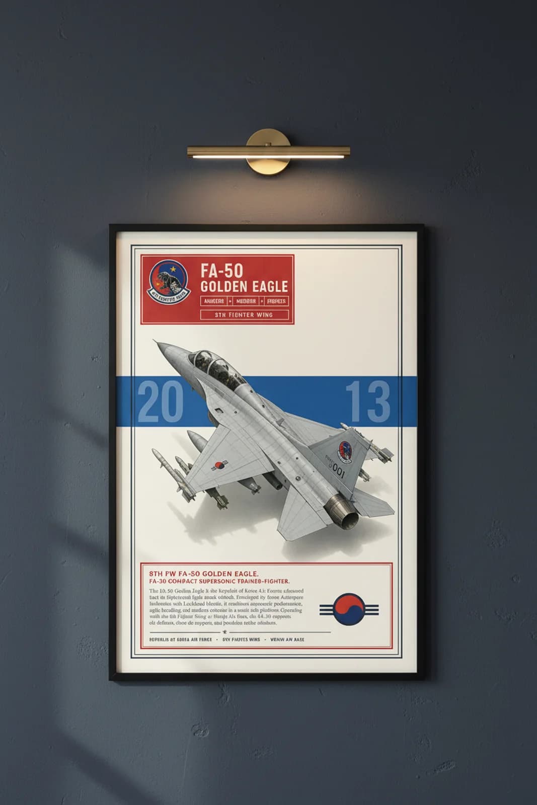 FA-50 Golden Eagle aviation poster in black A2 frame on light-grey-livery navy hangar wall — Aviation Heroes mockup
