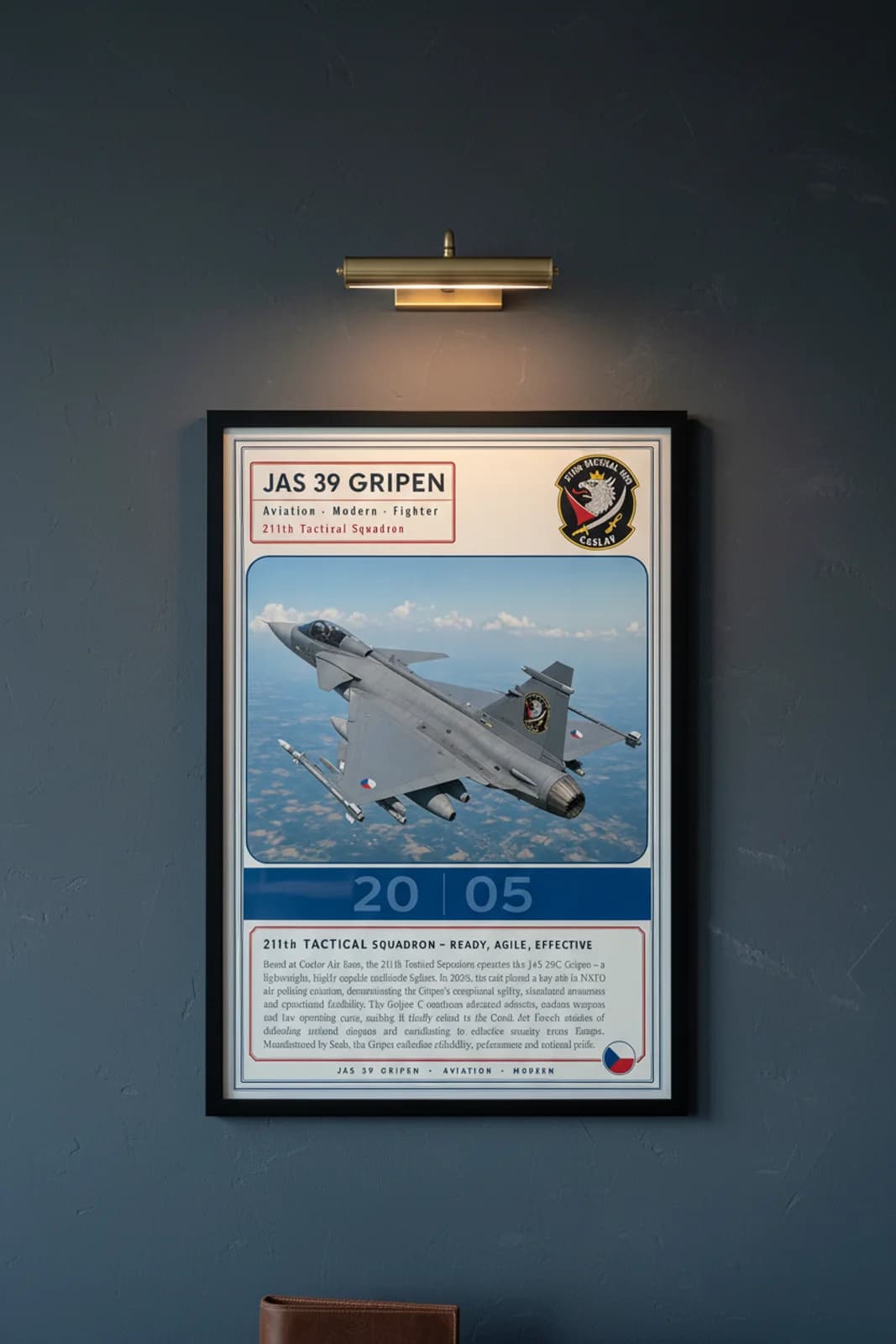 JAS 39 Gripen aviation poster in black A2 frame on czech-grey navy hangar wall — Aviation Heroes mockup
