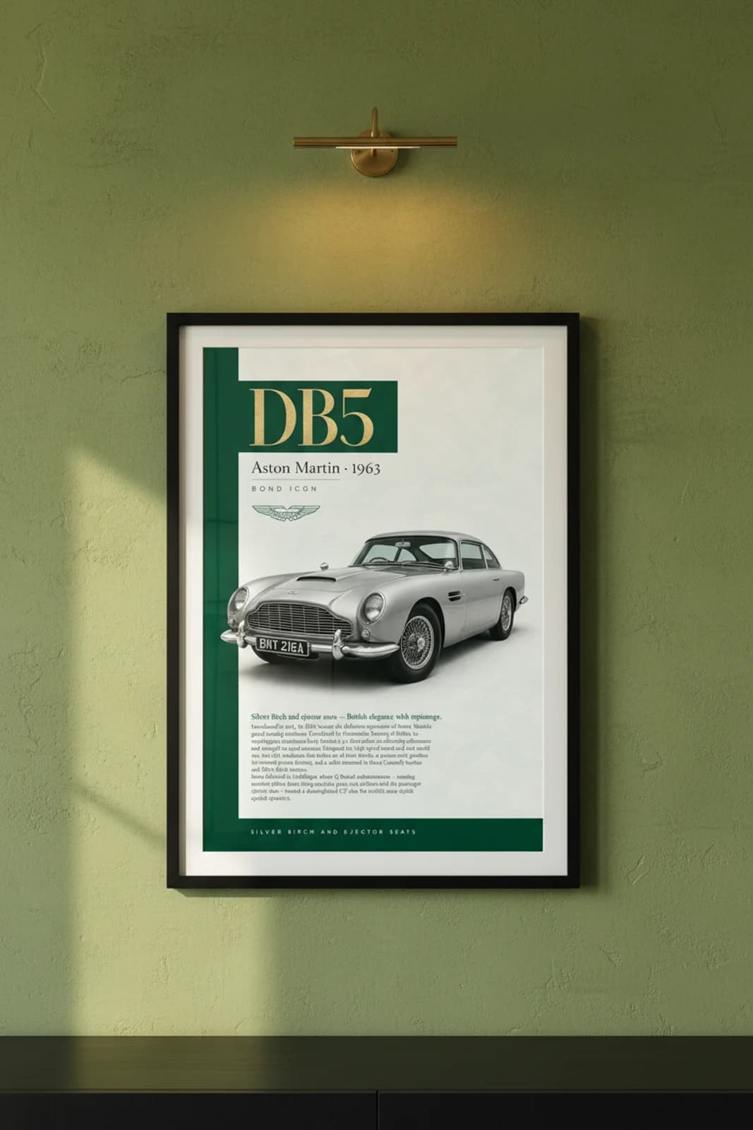 DB5 poster in black A2 frame on british-racing-green-header lime-wash wall — Heritage Icons collector lounge mockup