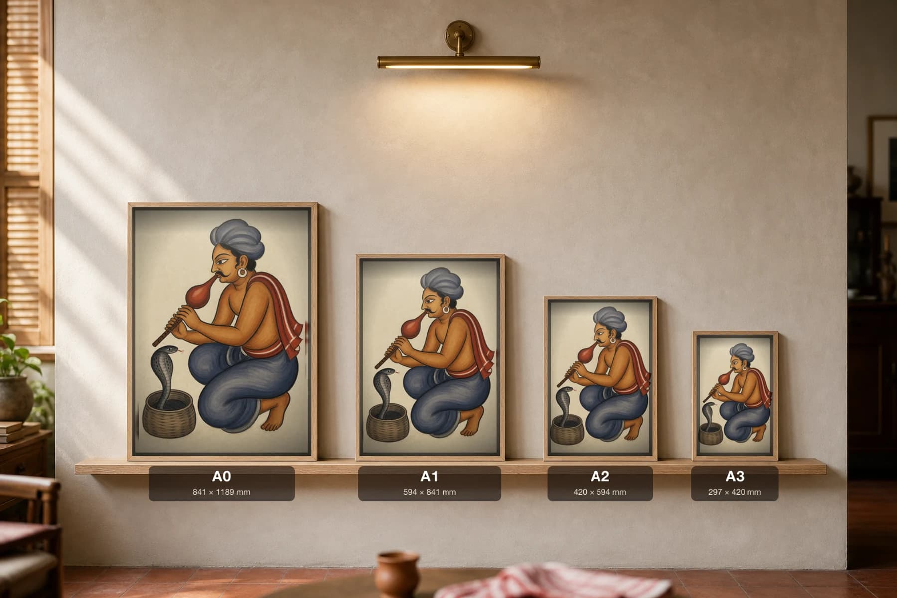 The Snake Charmer — Kalighat-style art print of a been-player coaxing a cobra from its basket, Bengal patua brush · collector edition · framed A2 — print size guide showing the artwork at A0, A1, A2 and A3 in natural-oak frames at true relative scale