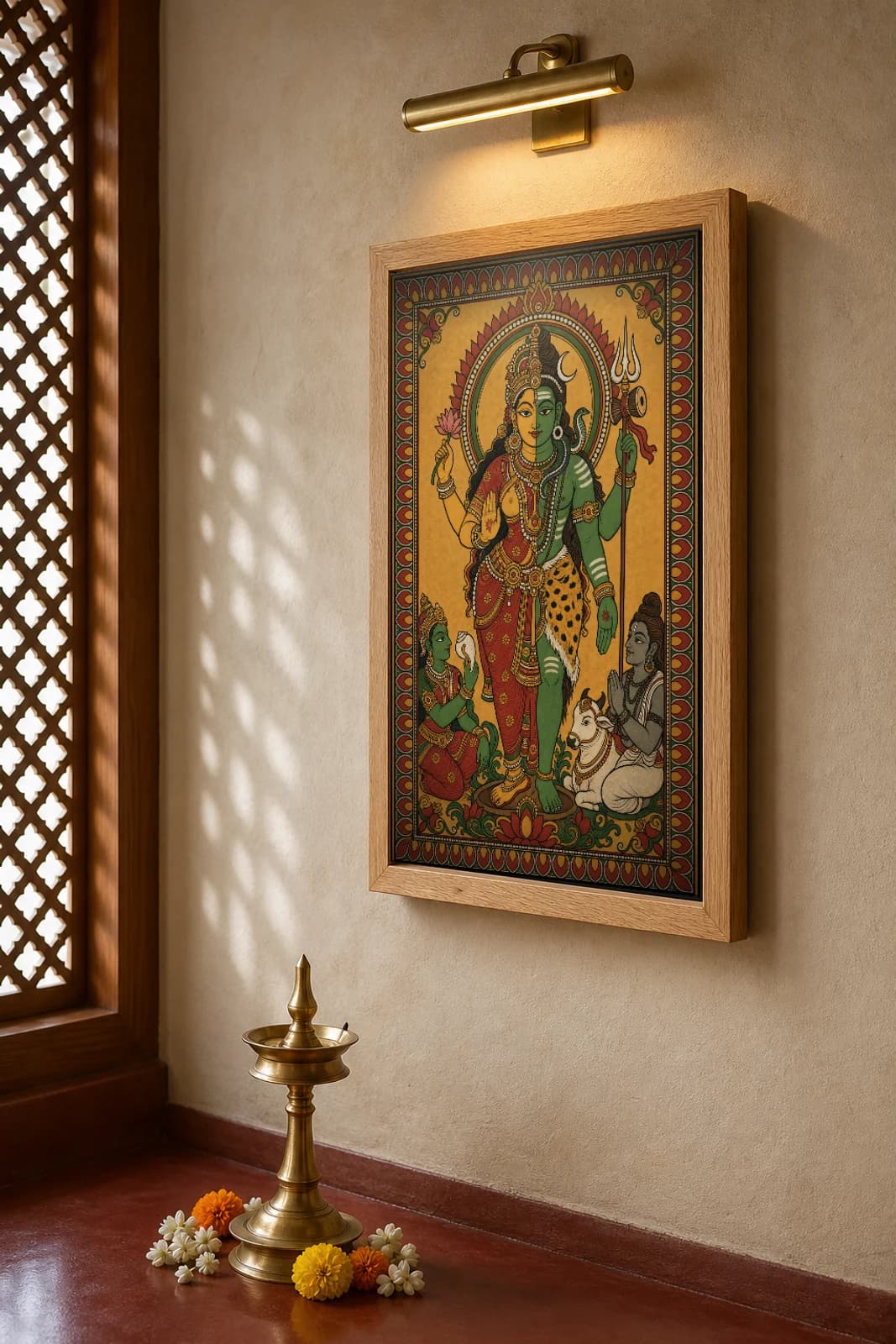 Ardhanareeswara Kerala Mural Art Print — half-Shiva half-Parvati composite in flat panchavarna bhitti-chitra style, collector edition of 500 — the framed print shown at a three-quarter angle on a styled gallery wall in a natural-oak frame