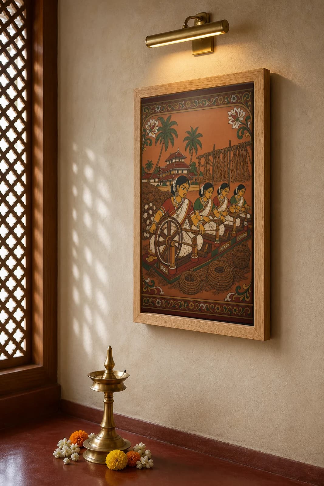Coir Spinning Yard Kerala Mural Art Print — women spinning coconut-fibre coir in flat panchavarna bhitti-chitra style, collector edition of 500 — the framed print shown at a three-quarter angle on a styled gallery wall in a natural-oak frame