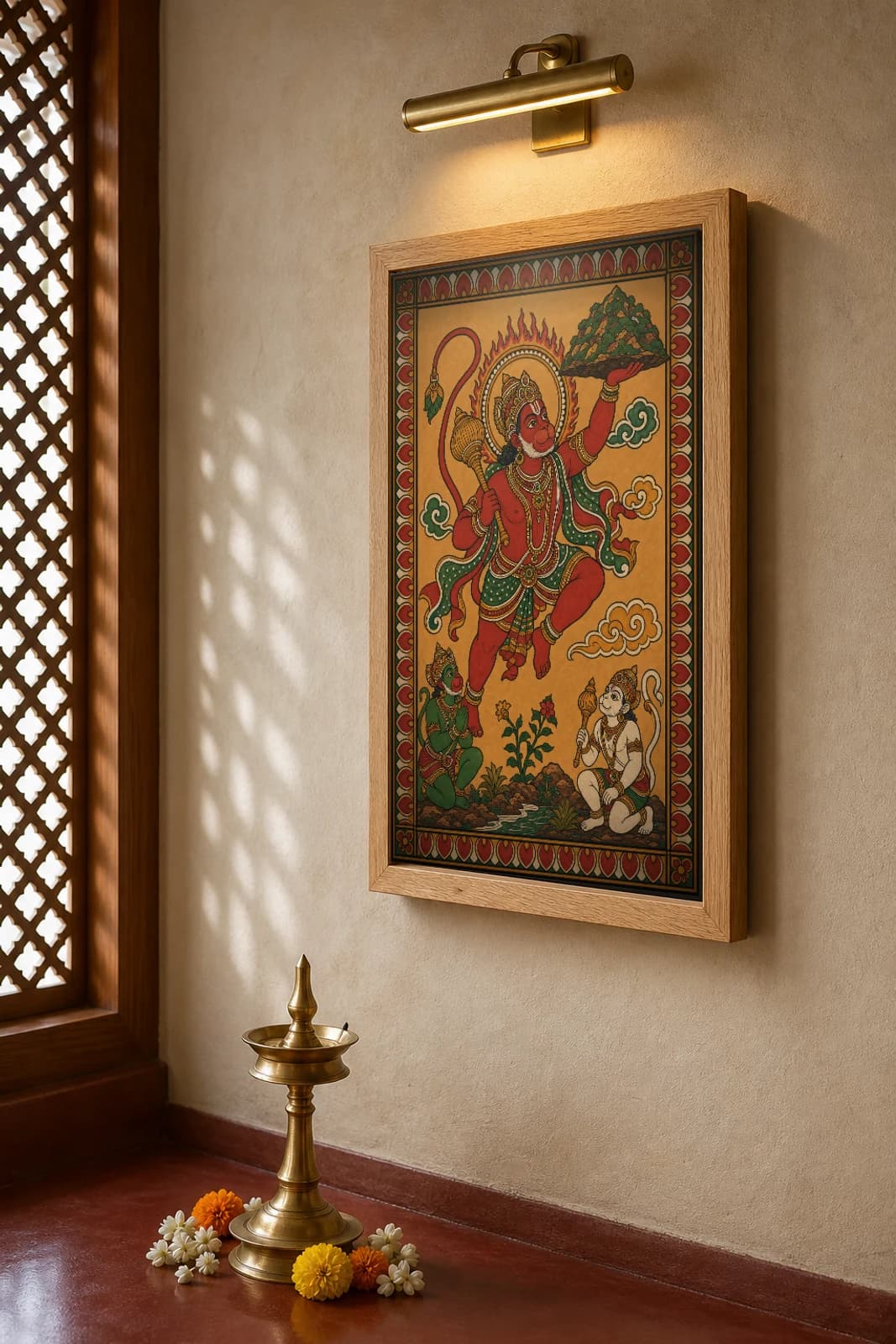 Hanuman Kerala Mural Art Print — flying Hanuman bearing the Sanjivani mountain in flat panchavarna bhitti-chitra style, collector edition of 500 — the framed print shown at a three-quarter angle on a styled gallery wall in a natural-oak frame