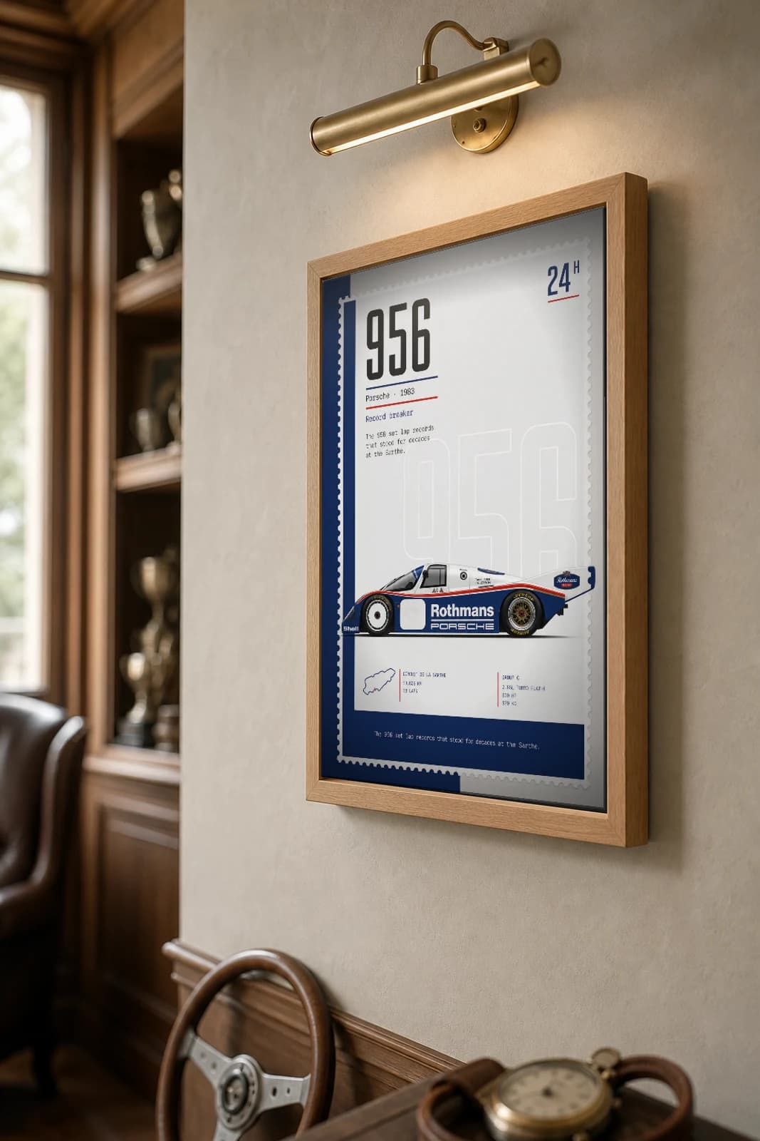 Porsche 956 Poster — 1983 24 Hours of Le Mans Endurance Racing Wall Art · framed A2 — the framed print shown at a three-quarter angle on a styled gallery wall in a natural-oak frame