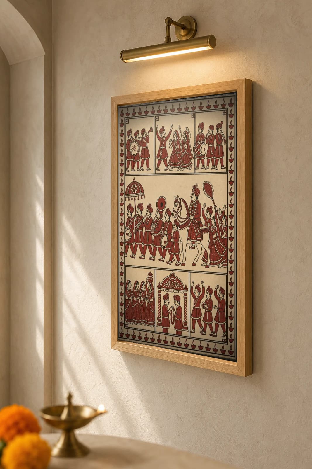 The Wedding Band — Mata ni Pachedi shrine cloth · the groom on his white horse behind the brass baraat band, dancers and welcoming women alongside, in madder red on cream cotton — the framed print shown at a three-quarter angle on a styled gallery wall in a natural-oak frame