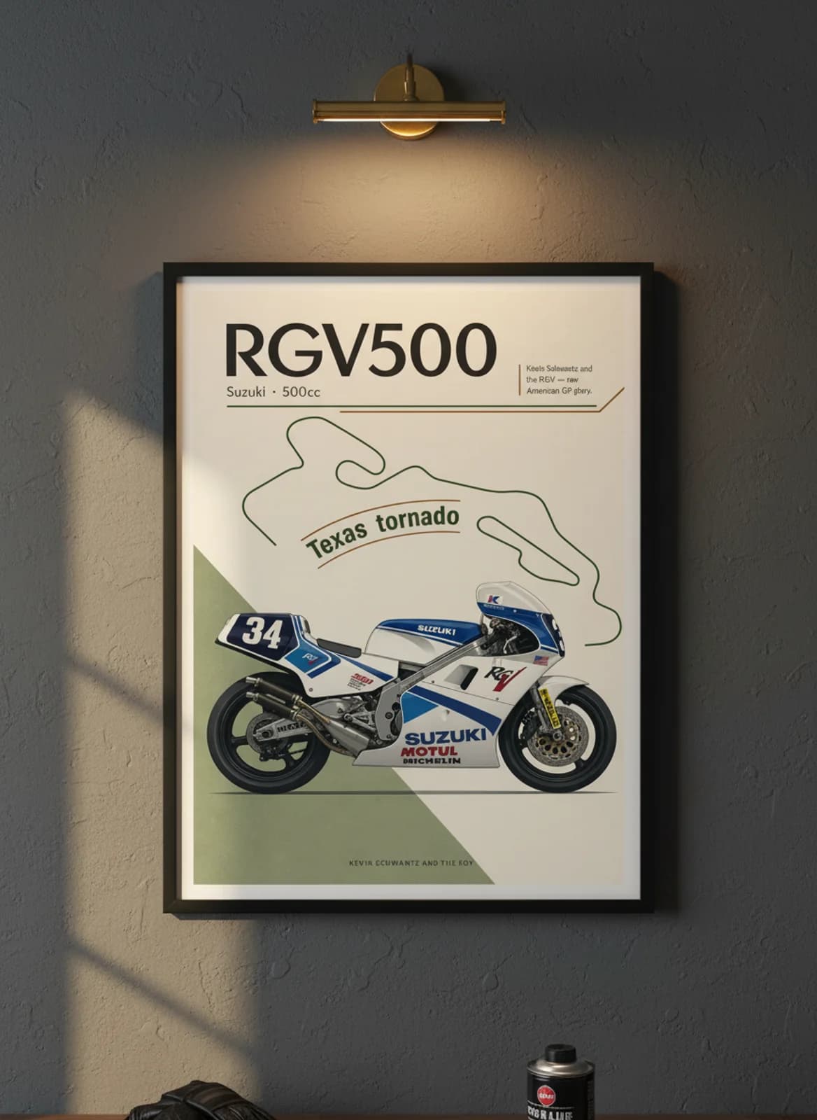 RGV500 MotoGP Legends print in black A2 frame on suzuki-blue charcoal garage wall — motorcycle lounge mockup