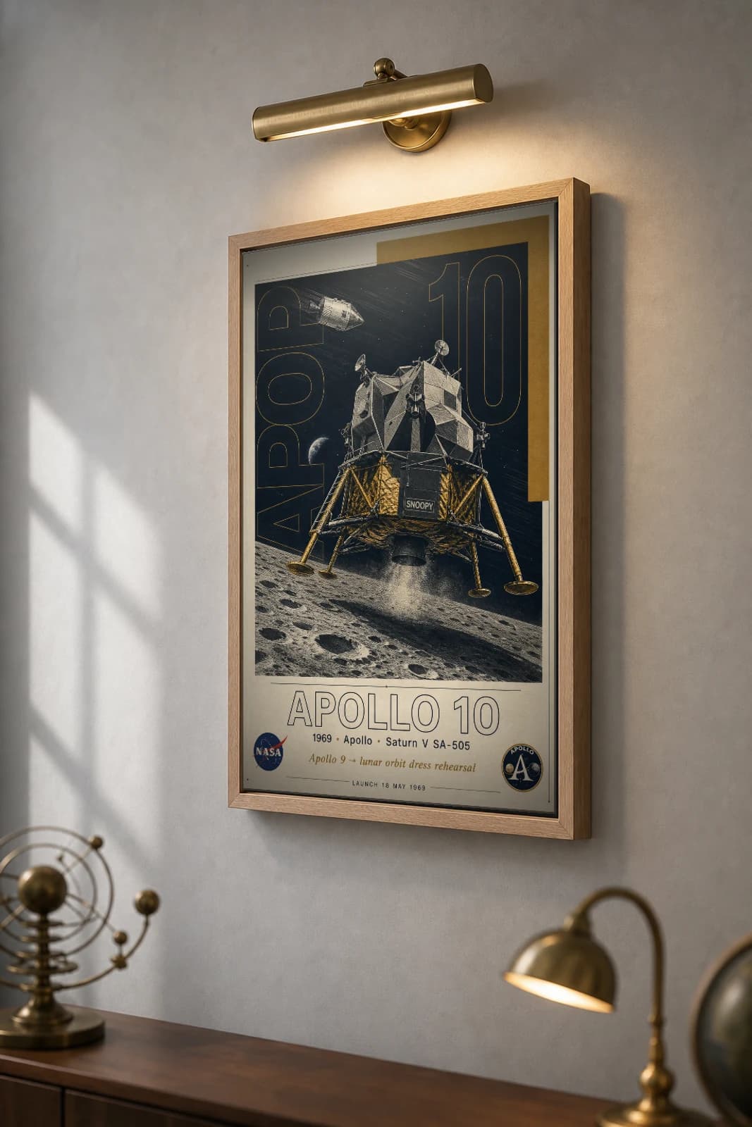 Apollo 10 Poster — 1969 Snoopy LM Lunar Rehearsal NASA Heritage Collector Print — the framed print shown at a three-quarter angle on a styled gallery wall in a natural-oak frame