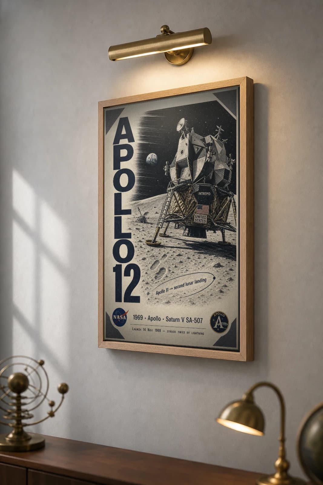 Apollo 12 Poster — 1969 Intrepid LM Ocean of Storms NASA Heritage Collector Print — the framed print shown at a three-quarter angle on a styled gallery wall in a natural-oak frame