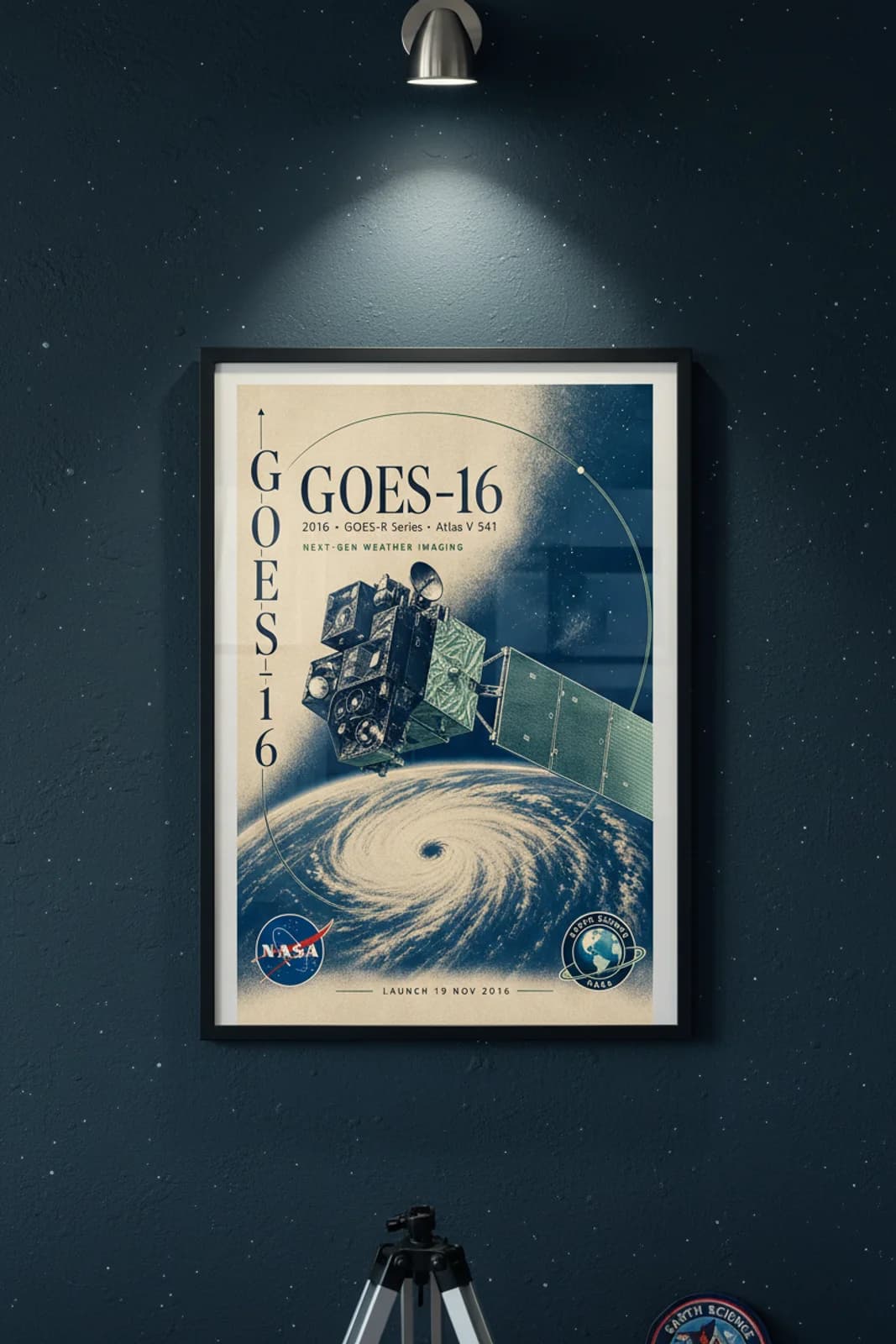 GOES-16 poster in black A2 frame on navy-teal-spacecraft deep space navy wall — NASA Heritage collector study mockup