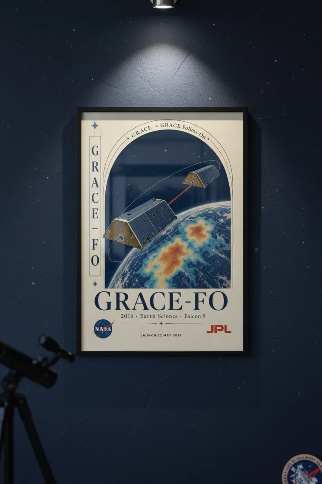 GRACE-FO poster in black A2 frame on navy-arch-frame deep space navy wall — NASA Heritage collector study mockup