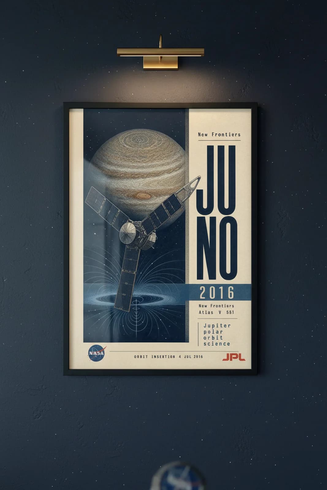 Juno poster in black A2 frame on jupiter-band-orange-tan deep space navy wall — NASA Heritage collector study mockup