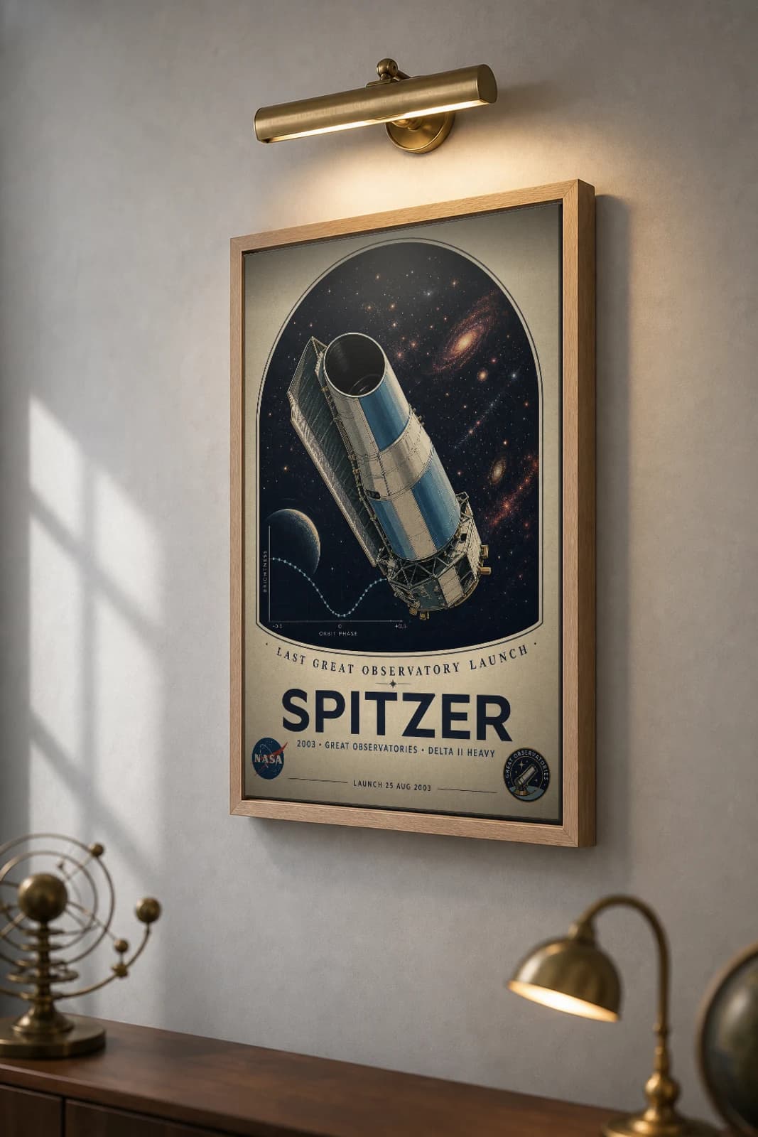 Spitzer Poster — 2003 Infrared Great Observatory NASA Heritage Collector Print — the framed print shown at a three-quarter angle on a styled gallery wall in a natural-oak frame