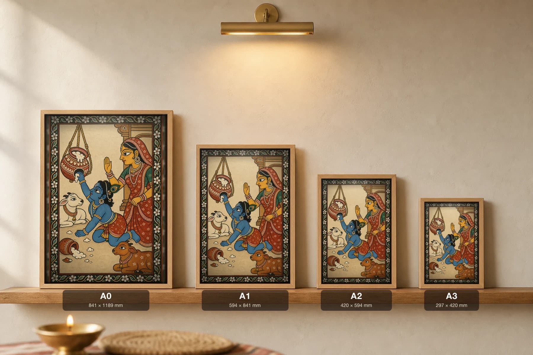 Makhan Chor Pattachitra Print — child Krishna and the butter pot in Odisha cloth-painting grammar · collector A2 · Krishna leela — print size guide showing the artwork at A0, A1, A2 and A3 in natural-oak frames at true relative scale