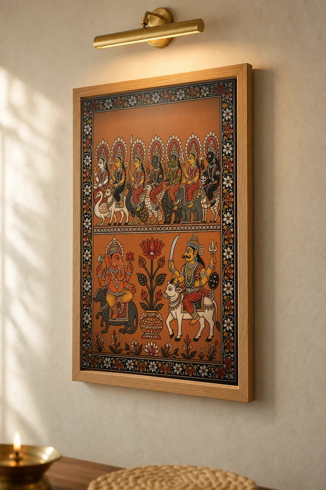 Sapta Matrika Pattachitra Print — the seven mother goddesses on their mounts in Odisha cloth-painting grammar · collector A2 · Devi / Shakti — the framed print shown at a three-quarter angle on a styled gallery wall in a natural-oak frame