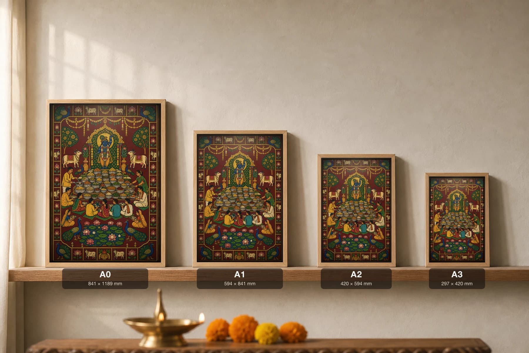 Community Bhandara Annakut Pichwai-Style Print — Shrinathji above a tiered mountain of food with a seated bhandara of devotees, peacocks and a lotus tank, on deep maroon cloth — print size guide showing the artwork at A0, A1, A2 and A3 in natural-oak frames at true relative scale