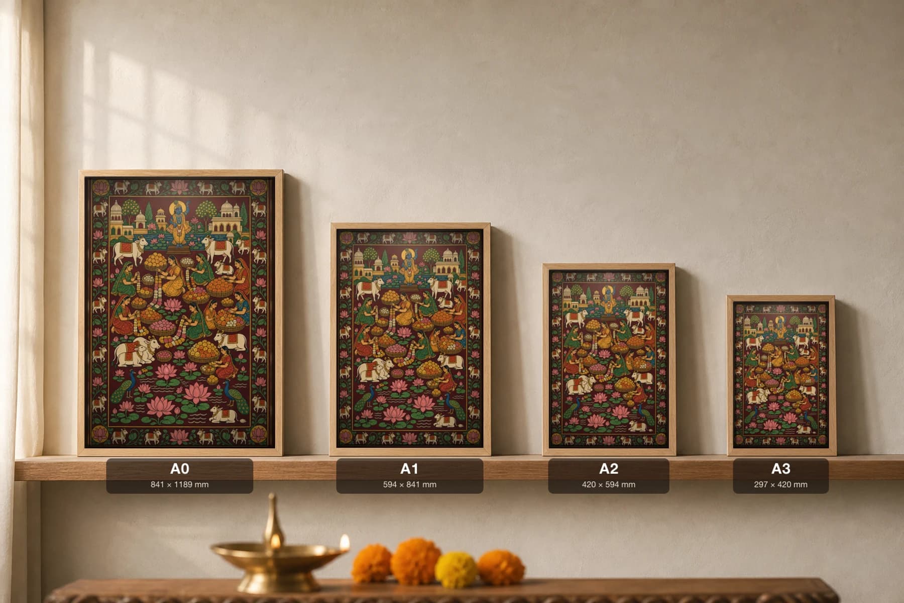 Phool Mandi Pichwai-Style Print — women weaving marigold garlands among baskets of flowers below a Krishna shrine, with cows, peacocks and a lotus pond, on deep maroon cloth — print size guide showing the artwork at A0, A1, A2 and A3 in natural-oak frames at true relative scale