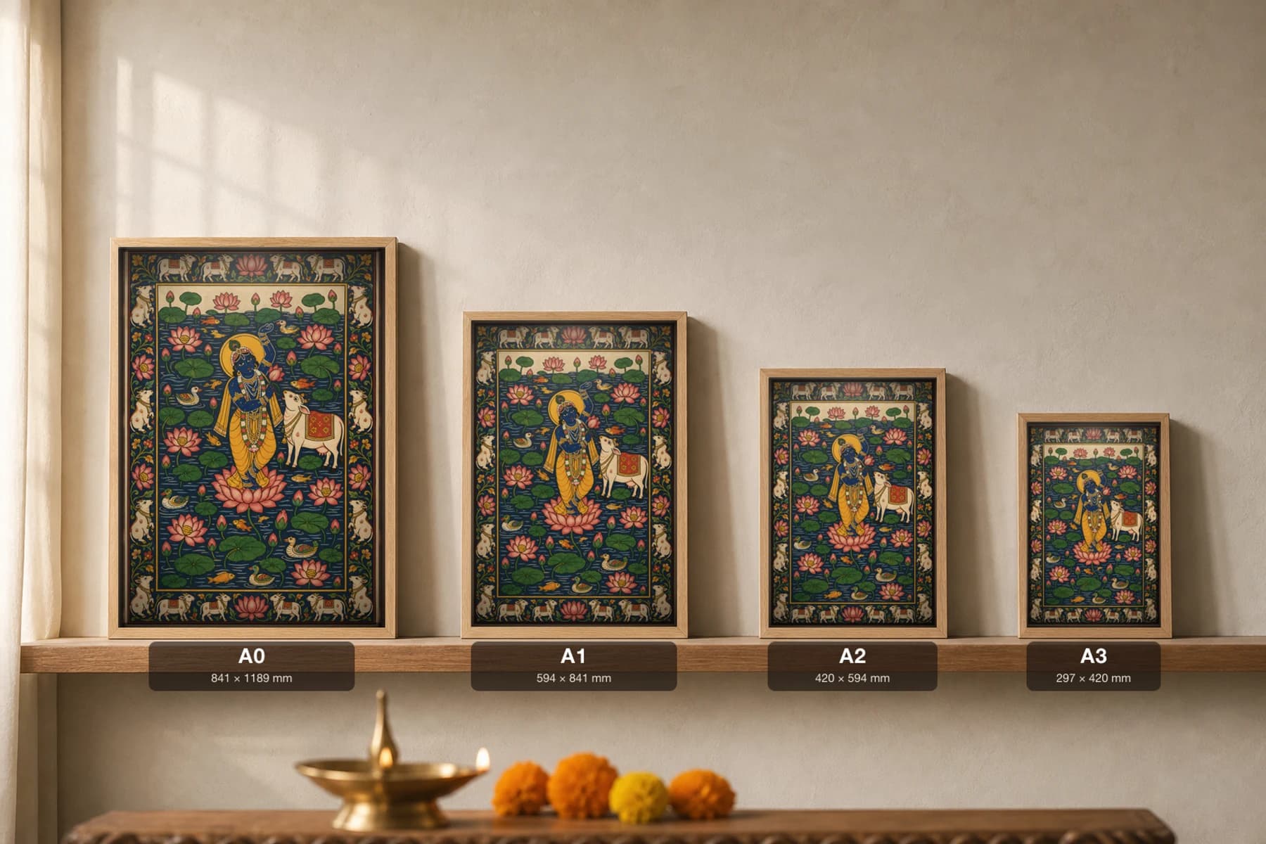 Kamal Talai Pichwai-Style Print — flute Krishna standing on a lotus in a lily pond with a white cow, fish, ducks and pink blooms, on deep indigo water cloth — print size guide showing the artwork at A0, A1, A2 and A3 in natural-oak frames at true relative scale