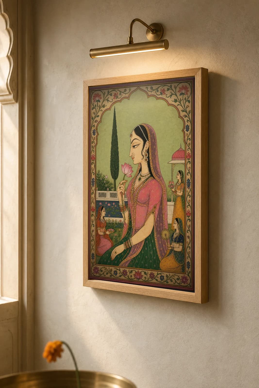 Bani Thani Rajput Miniature Print — the idealized Kishangarh profile in an arched garden, lotus in hand · collector edition A2 — the framed print shown at a three-quarter angle on a styled gallery wall in a natural-oak frame