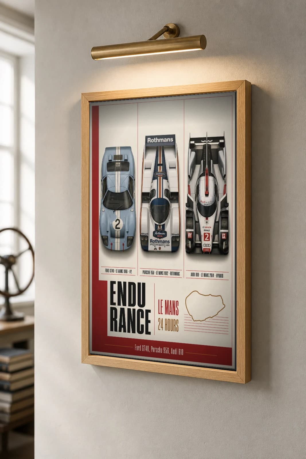 Factory / works endurance entries GT40 · 956 · R18 Poster —  Le Mans-winning sportscars · Group C prototype · LMP1 hybrid WEC racing wall art · #2 · framed A2 — the framed print shown at a three-quarter angle on a styled gallery wall in a natural-oak frame