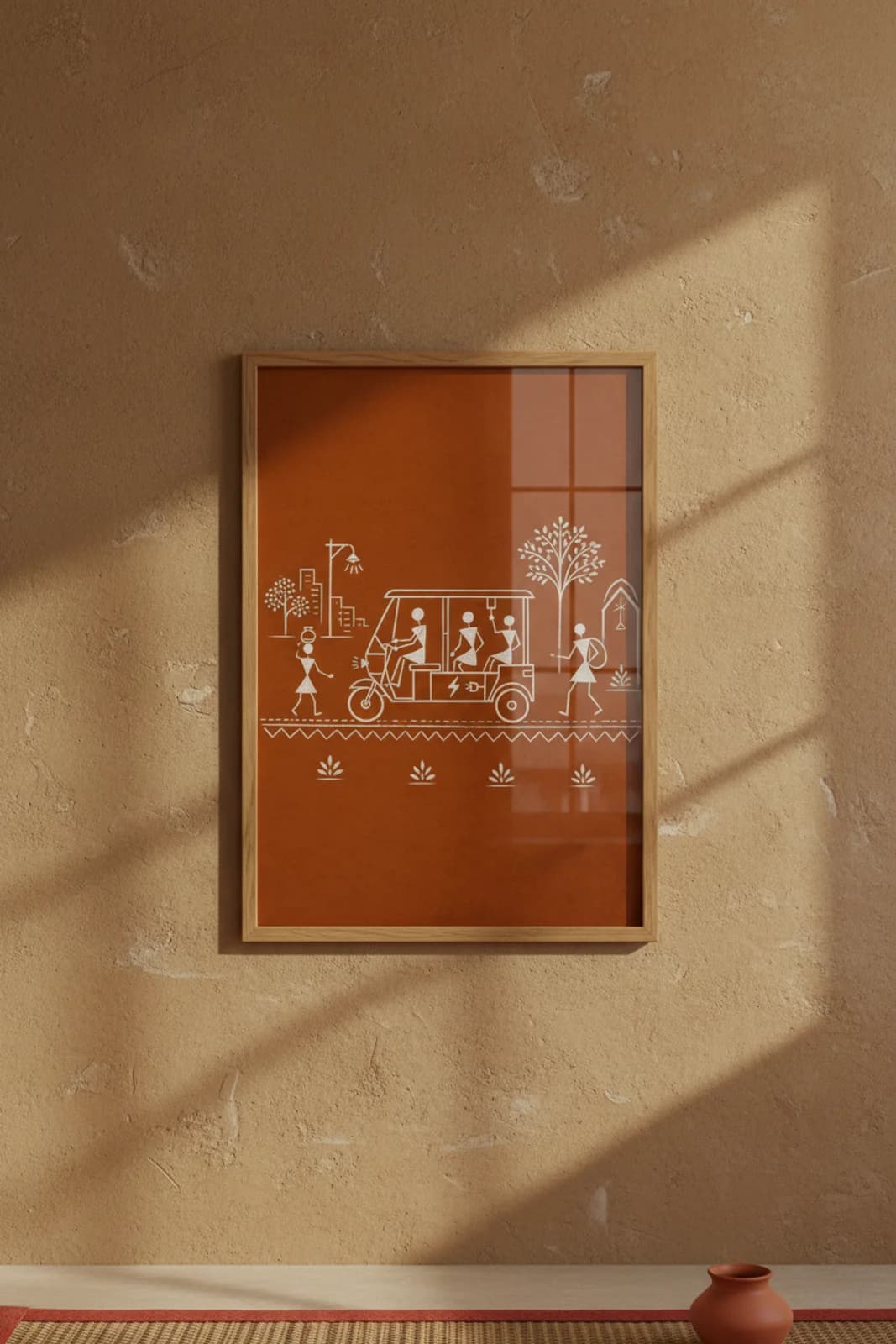 Electric Rickshaw Warli print in natural oak A2 frame on warm-earth-neutral mud-plaster wall — rustic Indian folk art mockup