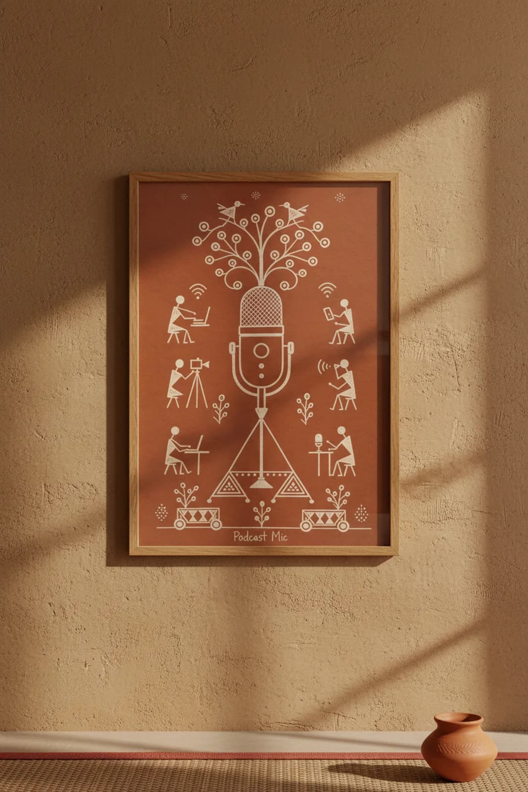 Podcast Mic Warli print in natural oak A2 frame on warm-earth-neutral mud-plaster wall — rustic Indian folk art mockup